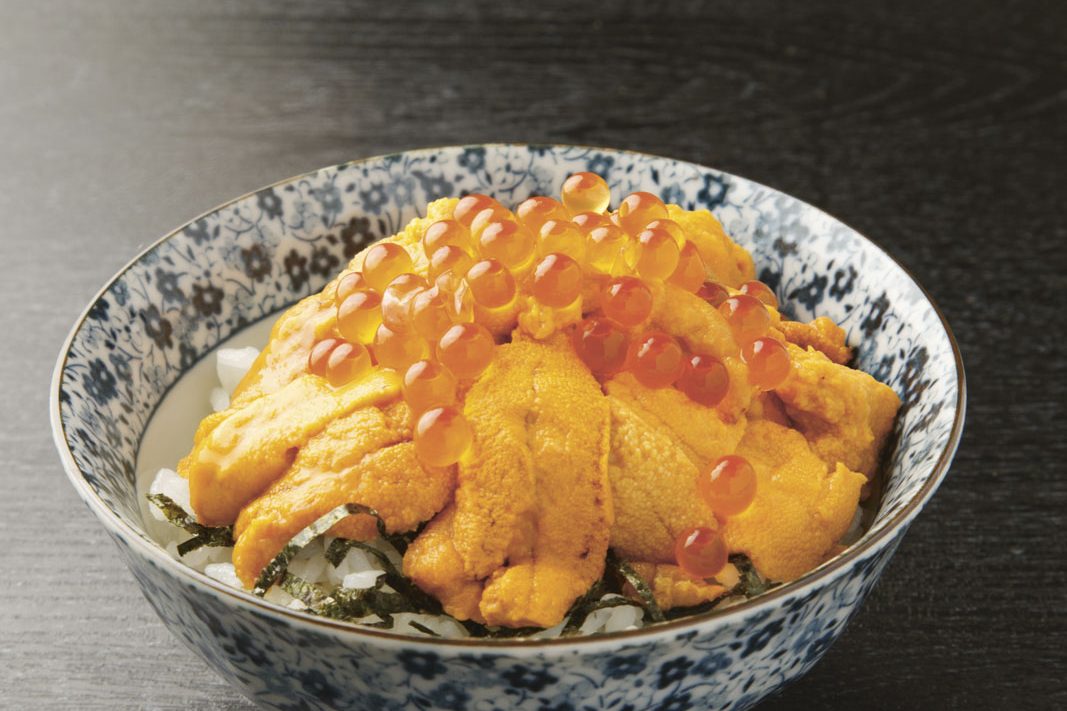 assortment of raw fish on a bowl of rice