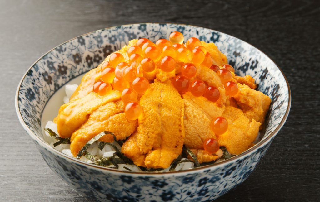 raw fish on a bowl of rice
