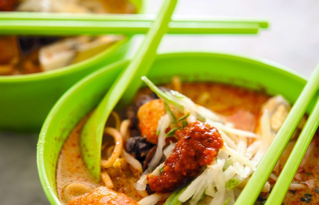 A bowl of laksa, a spicy noodle soup from the Peranakan or