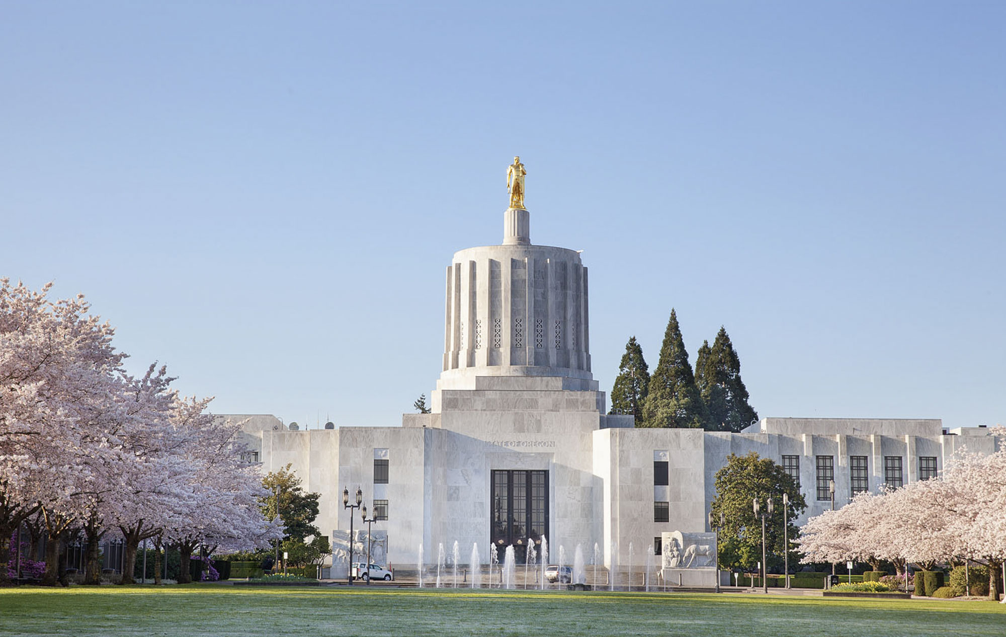 Salem Oregon State Capitol Building with Flowering Cherry Blossom Trees in Spring Season