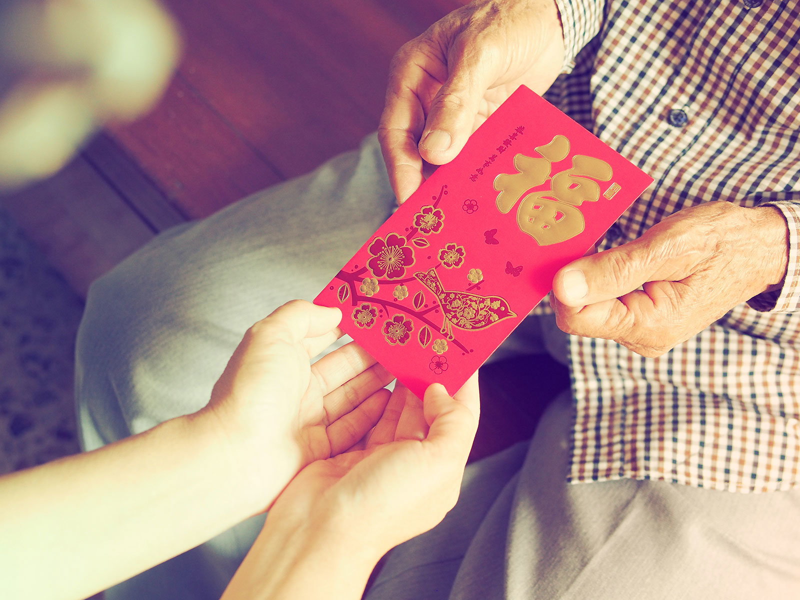 Relatives exchanging lai see packets during Chinese New Year