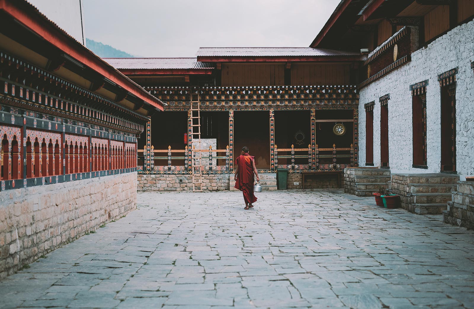 Monk with kettle Punahka Bhutan