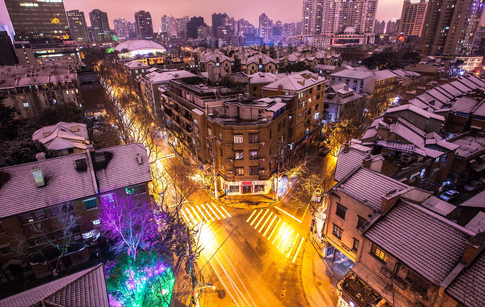Intersection of low-rise buildings in Shanghai's Former French Concession neighbourhood on a snowy night