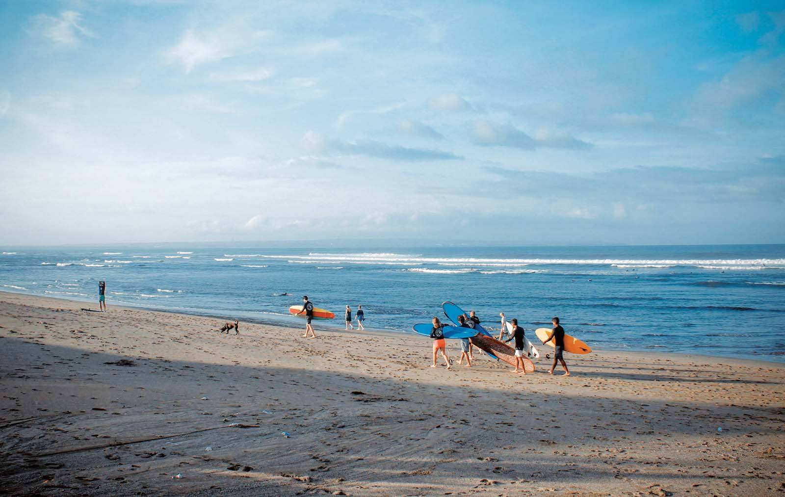 Surfers at Canggu beach in Bali, Indonesia