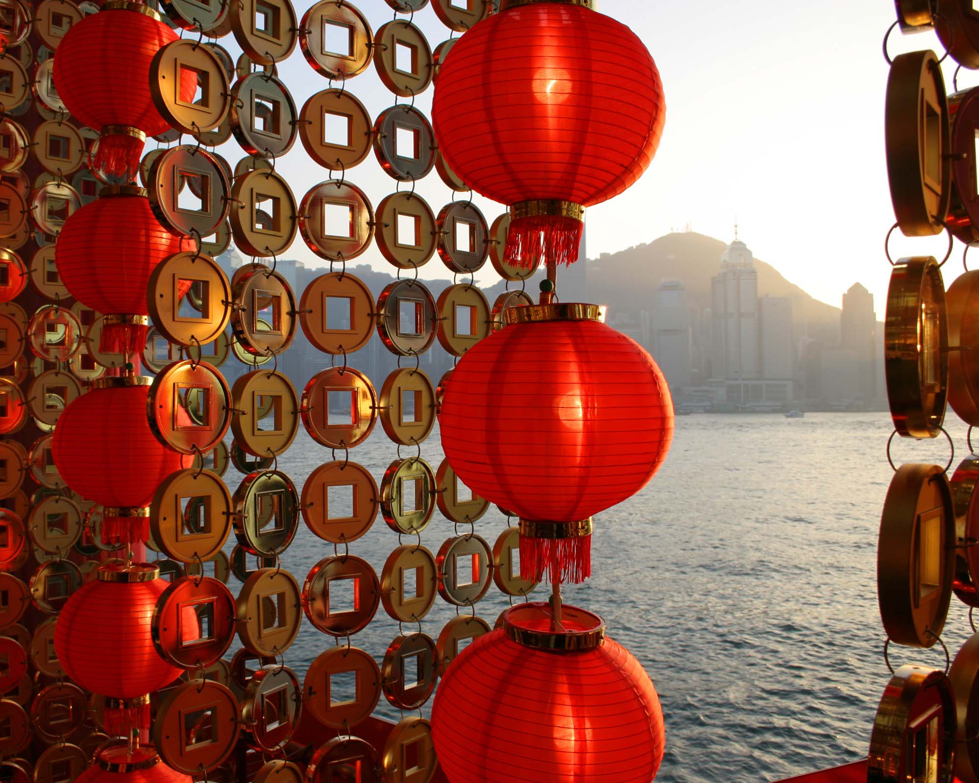 Chinese New Year red lanterns with Victoria Harbour and the Hong Kong skyline in the distance