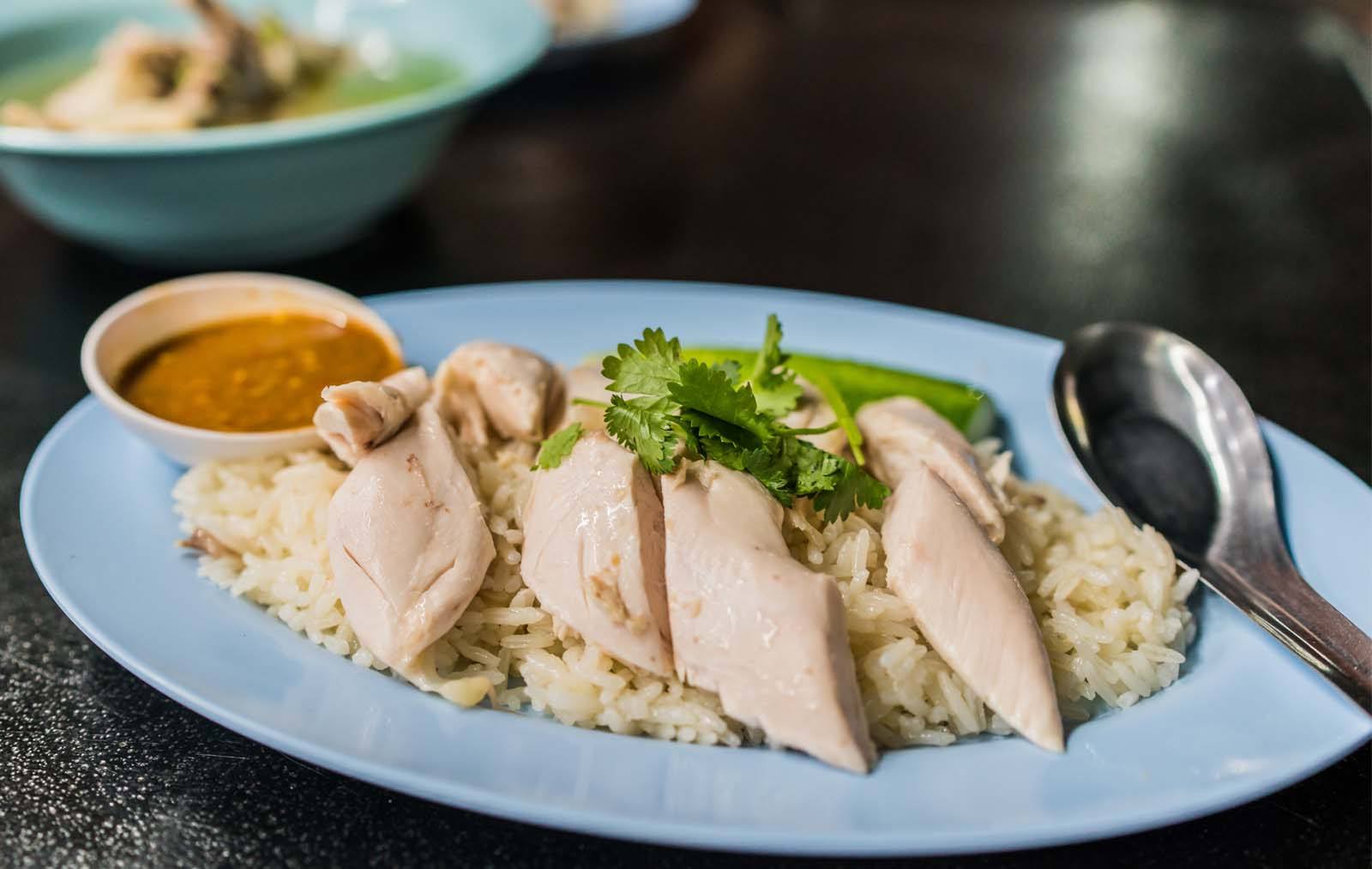 Thai chicken rice, a staple Bangkok street food, is adapted from Chinese-style Hainan chicken rice