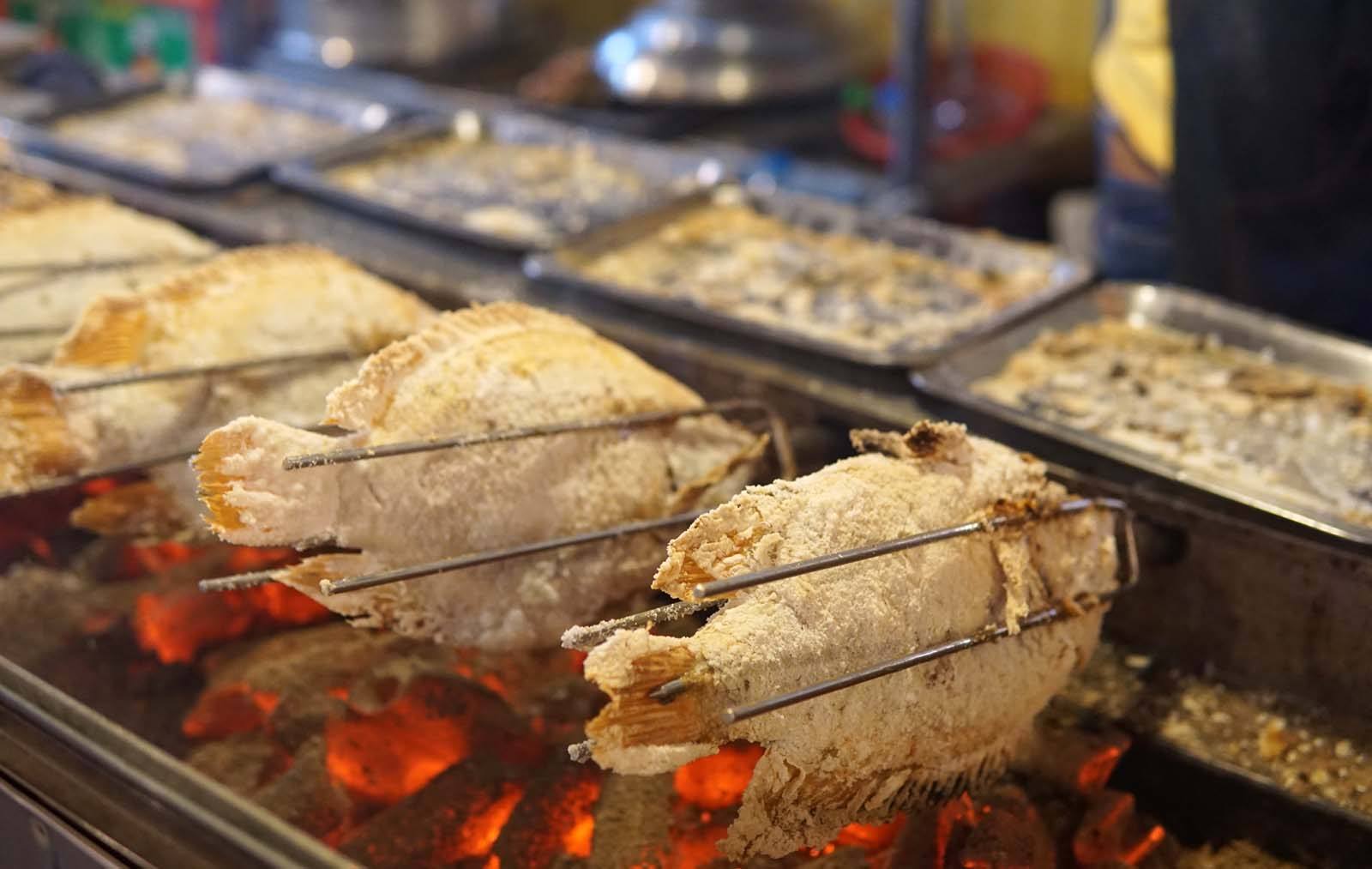Pla Pao (salt grilled fish) is a staple Bangkok street food at night markets in Thailand