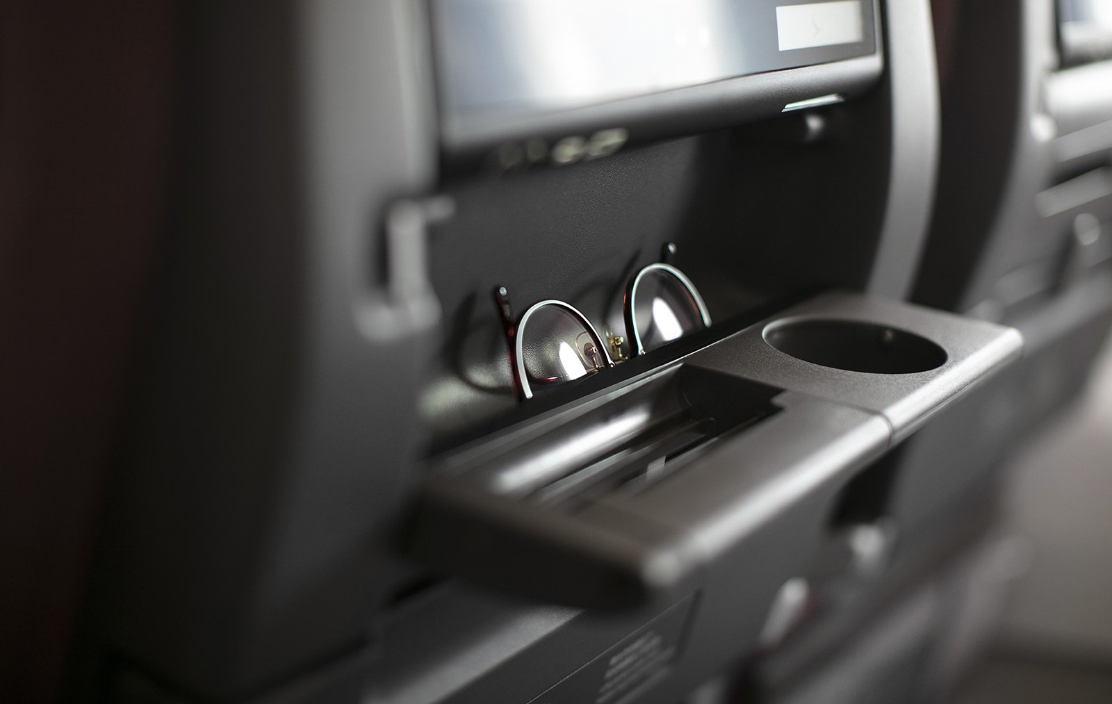 A pair of eyeglasses on the drop-down tablet holder on Cathay Pacific's new Airbus A321neo