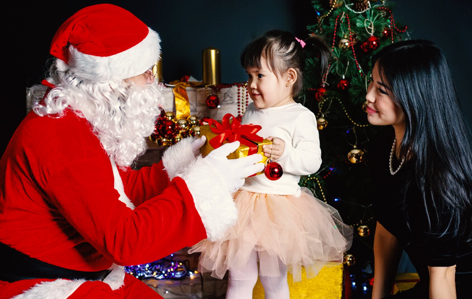 young girl meeting Santa Claus with mother