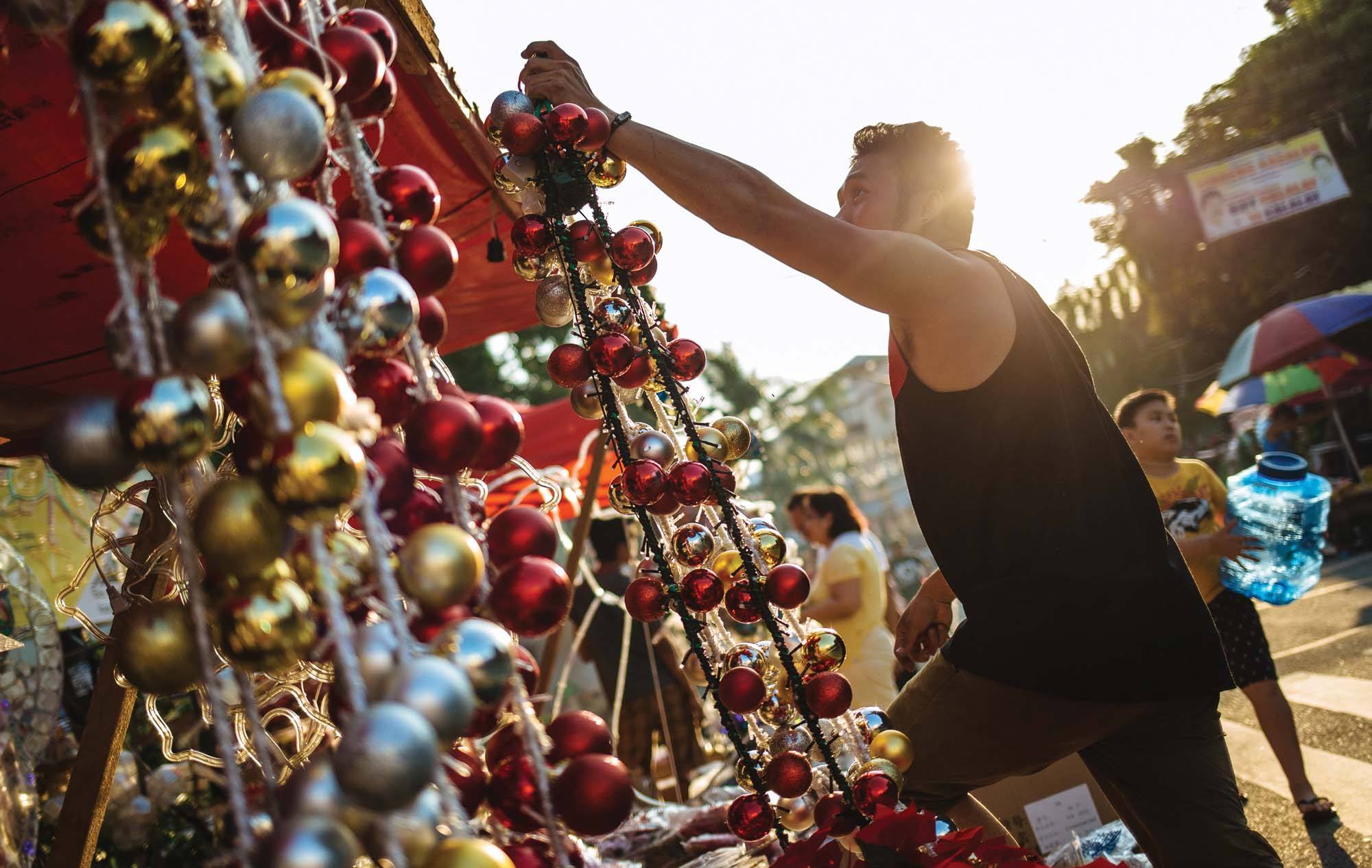 A man prepares Christmas decorations for sale in Dapitan Market, Quezon City, Manila, Philippines.