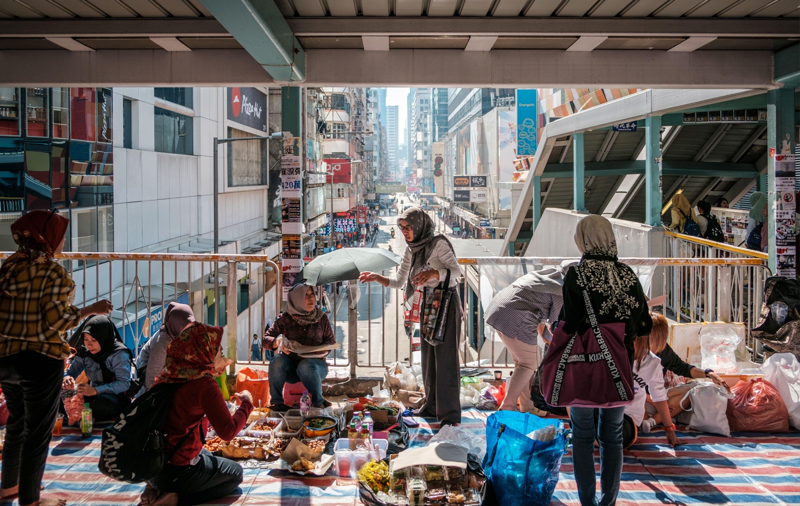 | helpers eating food on their day off in mongkok